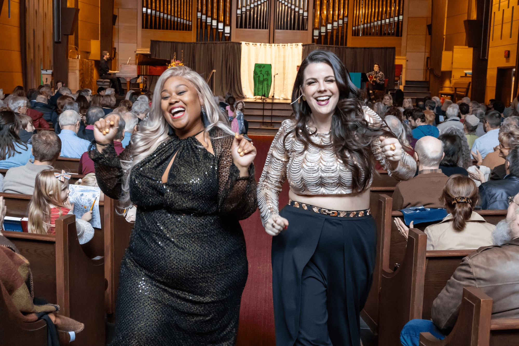 Abby Krawson and LaRiche Lamarr dancing joyfully down the church aisle